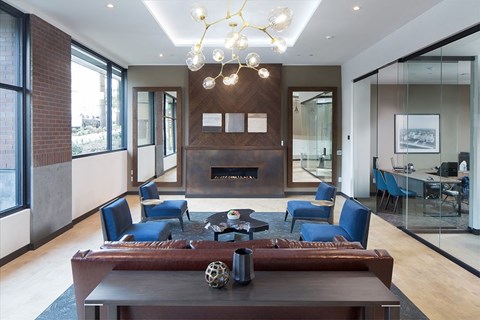 a living room with a fireplace and a table and chairs